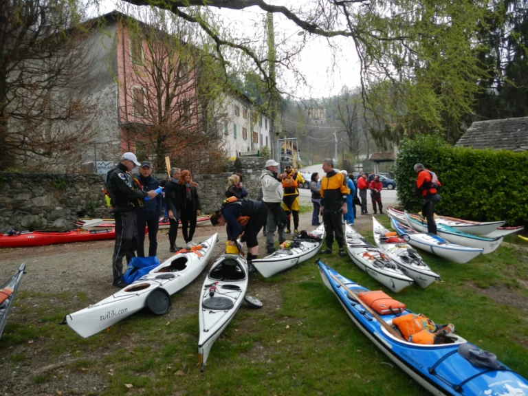 News Un giorno sul Cusio: partecipanti con i kayak sul prato in riva al lago